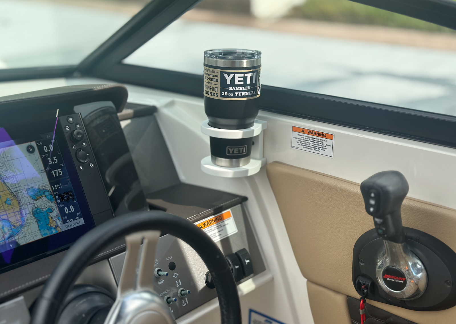 Tarpon Bay Marine cup holder mounted at the helm with a Yeti tumbler